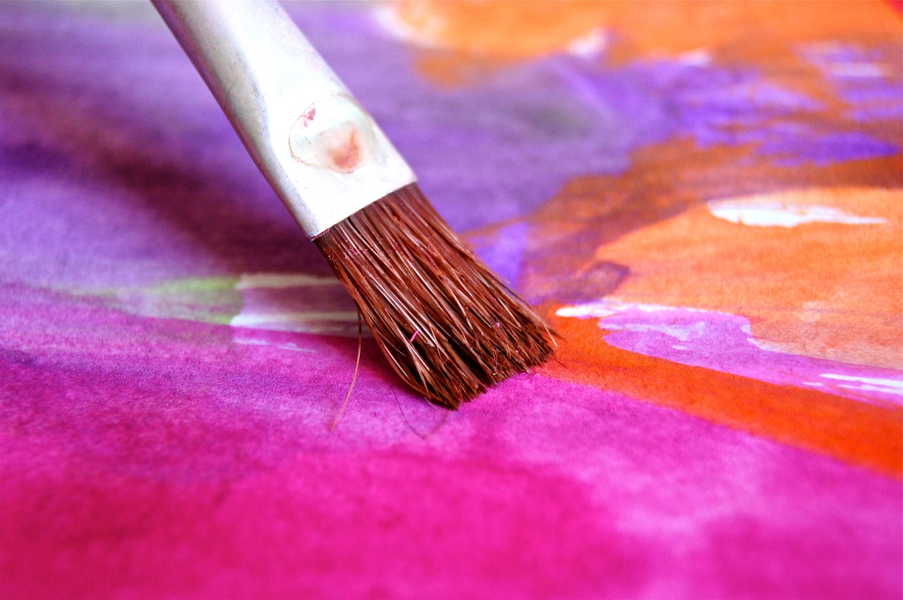 Paintbrush on colorful paint Paintbrush on colorful paint